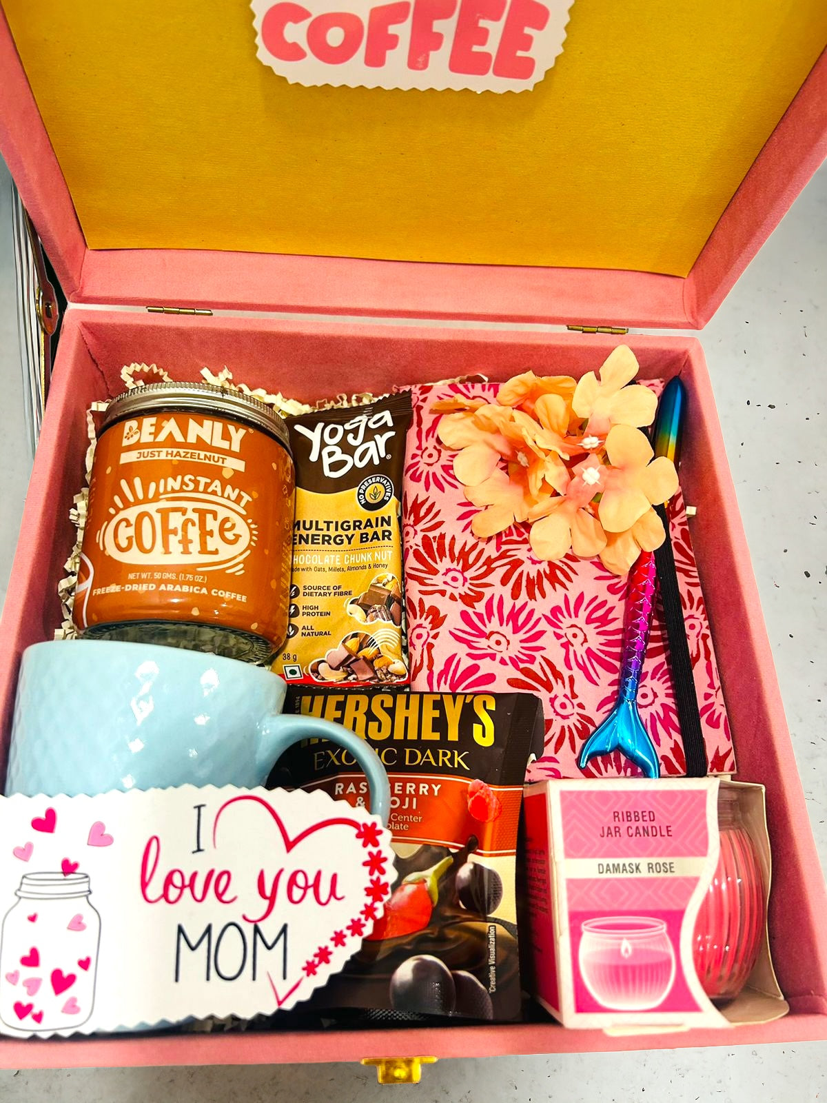 Ultimate gift hamper for women with coffee, chocolate, yoga energy bar, notebook, mug, and scented candle in a suede MDF box – perfect for all occasions.