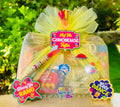 Holi celebration hamper with Gulal Blaster, organic gulal, snow spray, dry fruit gujiya, Shahi Thandai, and assorted snacks in a premium wooden tray.
