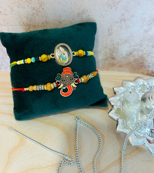 Set of 2 designer rakhis with Ganesh metal charms, vibrant threads, and roli chawal – traditional rakhi combo by Wrap Shap