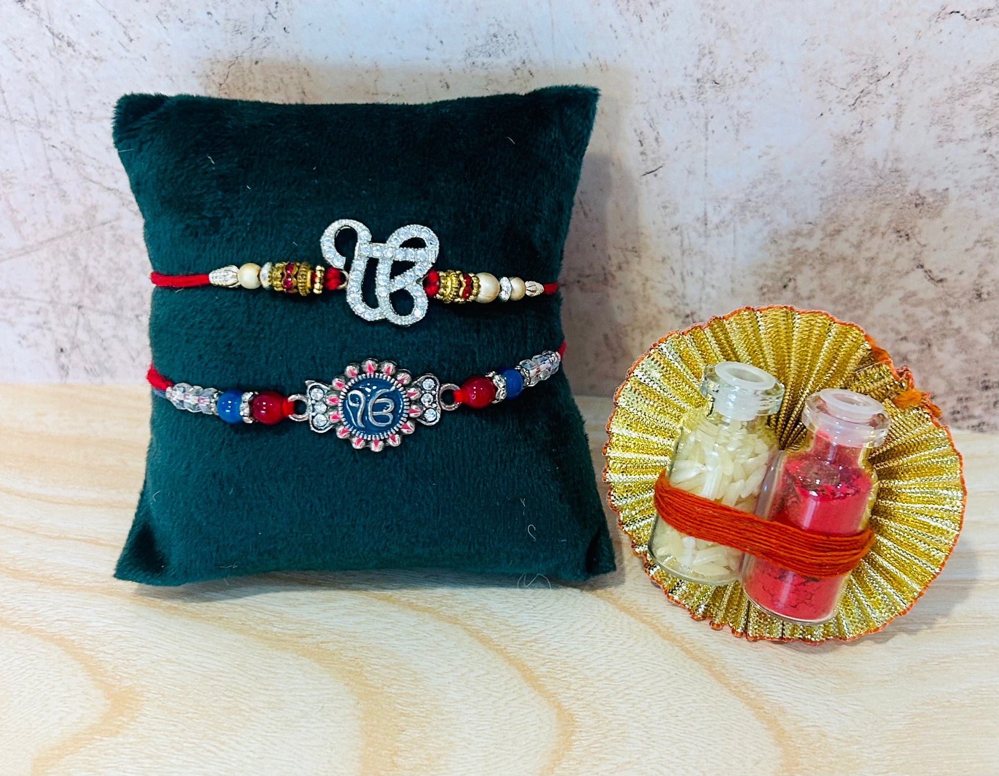 Set of 2 Ek Onkar Rakhis – one with engraved metal charm, one with AD stone design, includes roli chawal – Wrap Shap Rakhi Collection