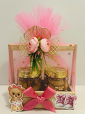 Decorated pinewood basket baby girl announcement return gift with cookies and soya chips jars.