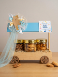 baby return gift hamper with almonds cookies and soya chips in hut wooden basket