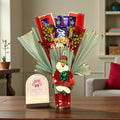 Christmas chocolate bouquet featuring Milka, Dairy Milk, KitKat, Kinder Joy and tree decorations.