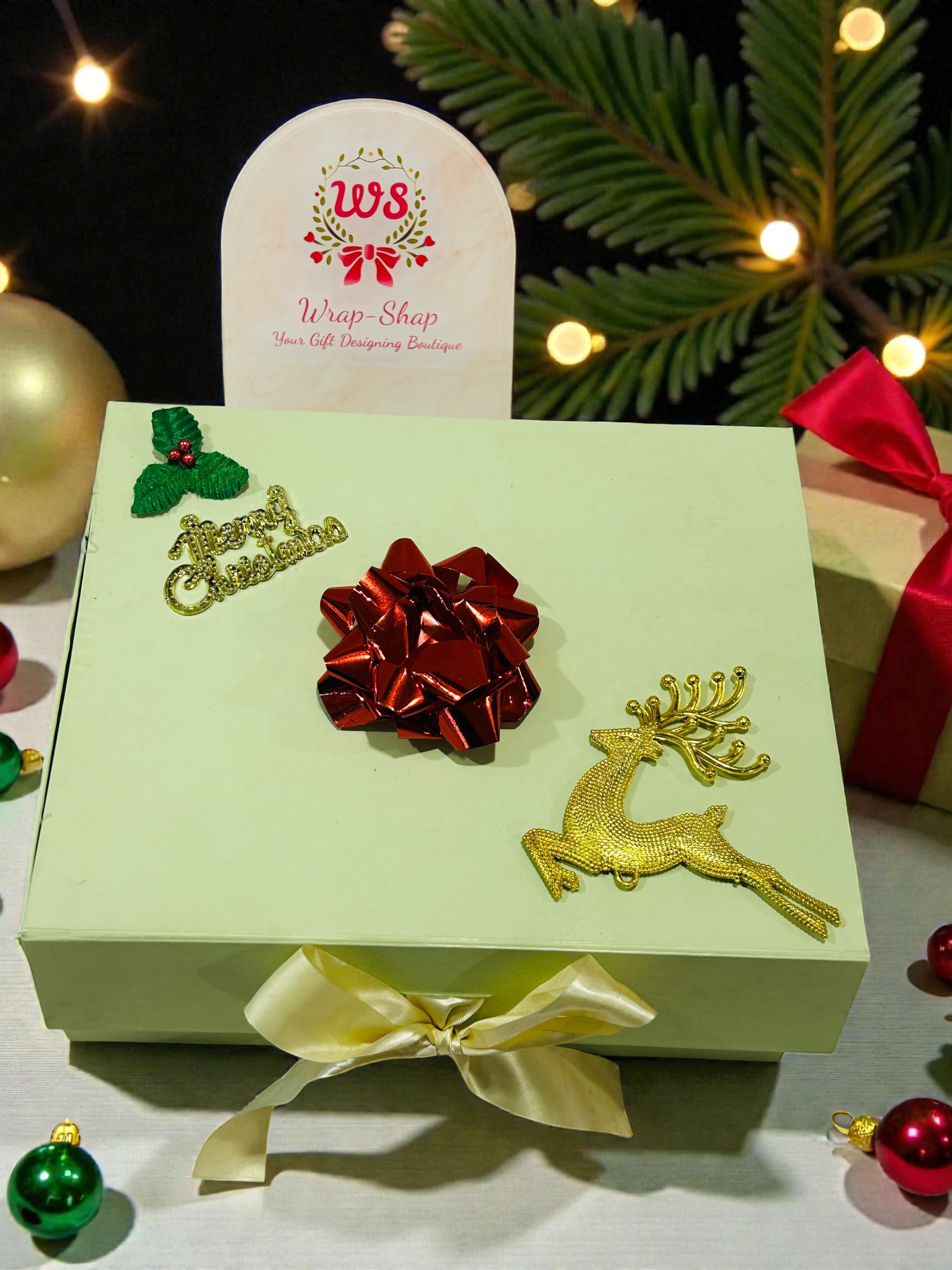 Christmas gift hamper with cookies, chocolates, two scented candles and tree decorative Santa.