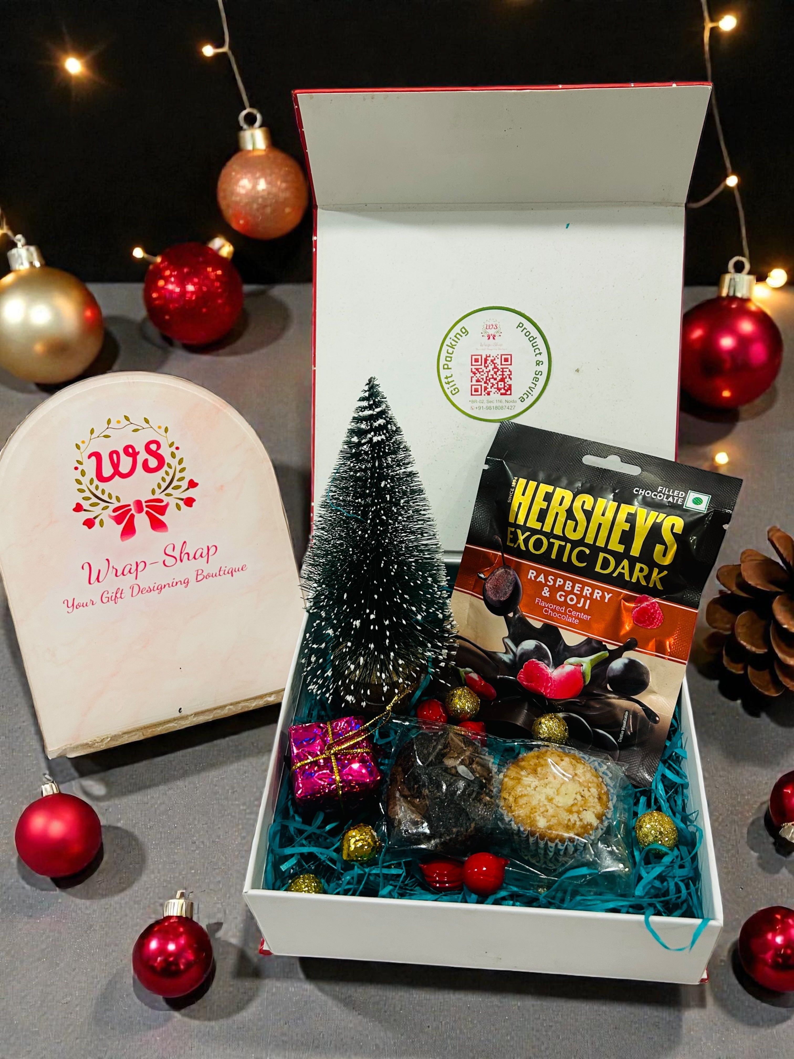 Christmas hamper in xmas themed magnetic gift box with table tree décor, chocolates and mini muffins.