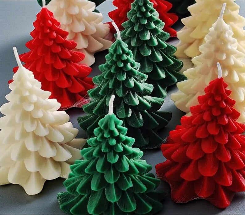 Small Christmas tree shaped decorative candles in assorted festive colors.