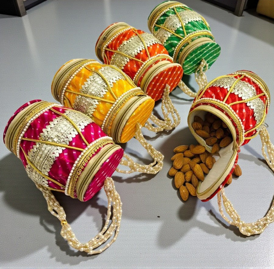 Dholak designer potli bag with double side opening and imitation pearl handle for wedding favours.
