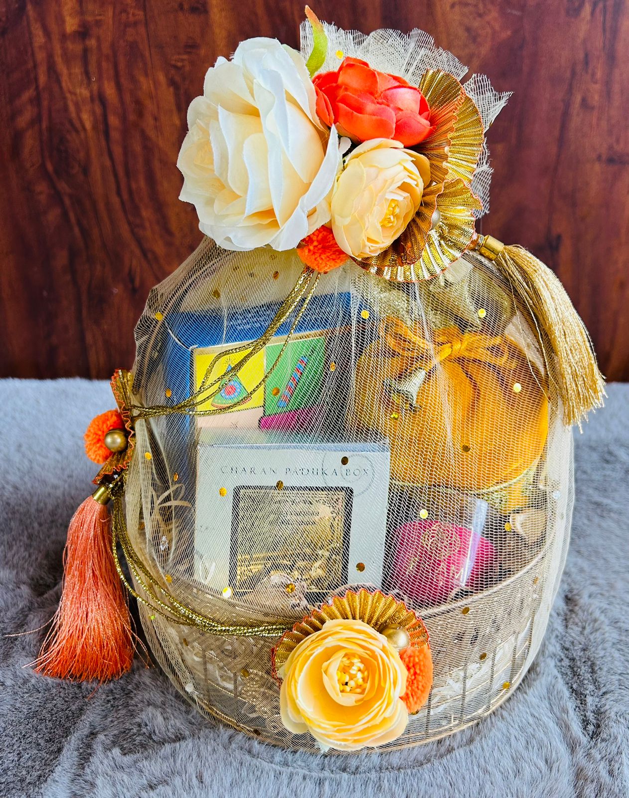 Luxury metal Diwali gift basket with coated dry fruits, Laxmi Charan Paduka, candle, plantable crackers, and velvet potli.