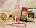 Dry Fruit Delight Mini Rakhi Hamper featuring a designer Rakhi, roasted pumpkin seeds, roasted cashews, Roli Chawal and reusable jute drawstring potli
