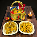 Lohri return gift hamper for first Lohri celebration with gajak, revdi, moongfali and popcorn in small basket.