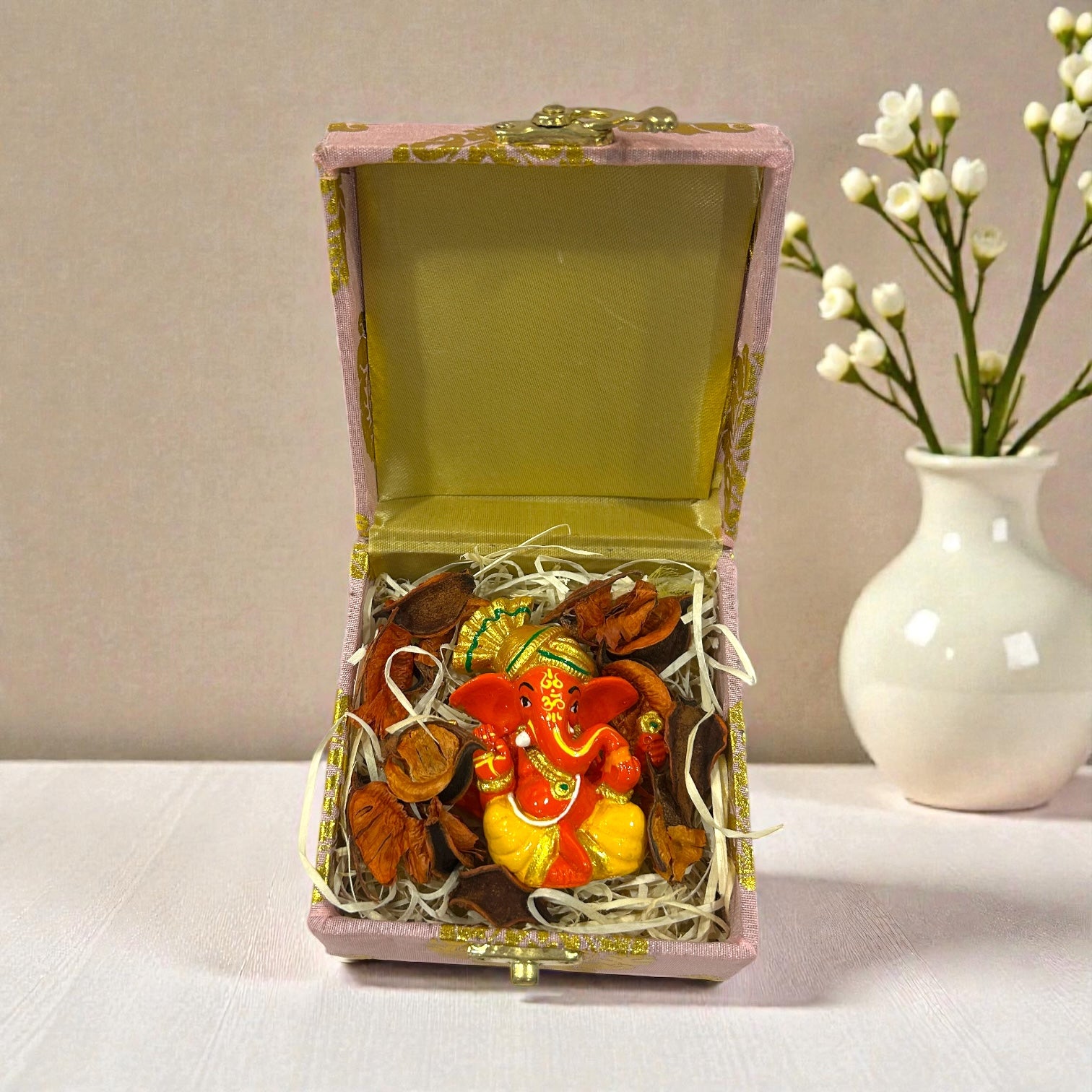 Wedding return favour with Ganesh Ji statue packed in a premium gift box.