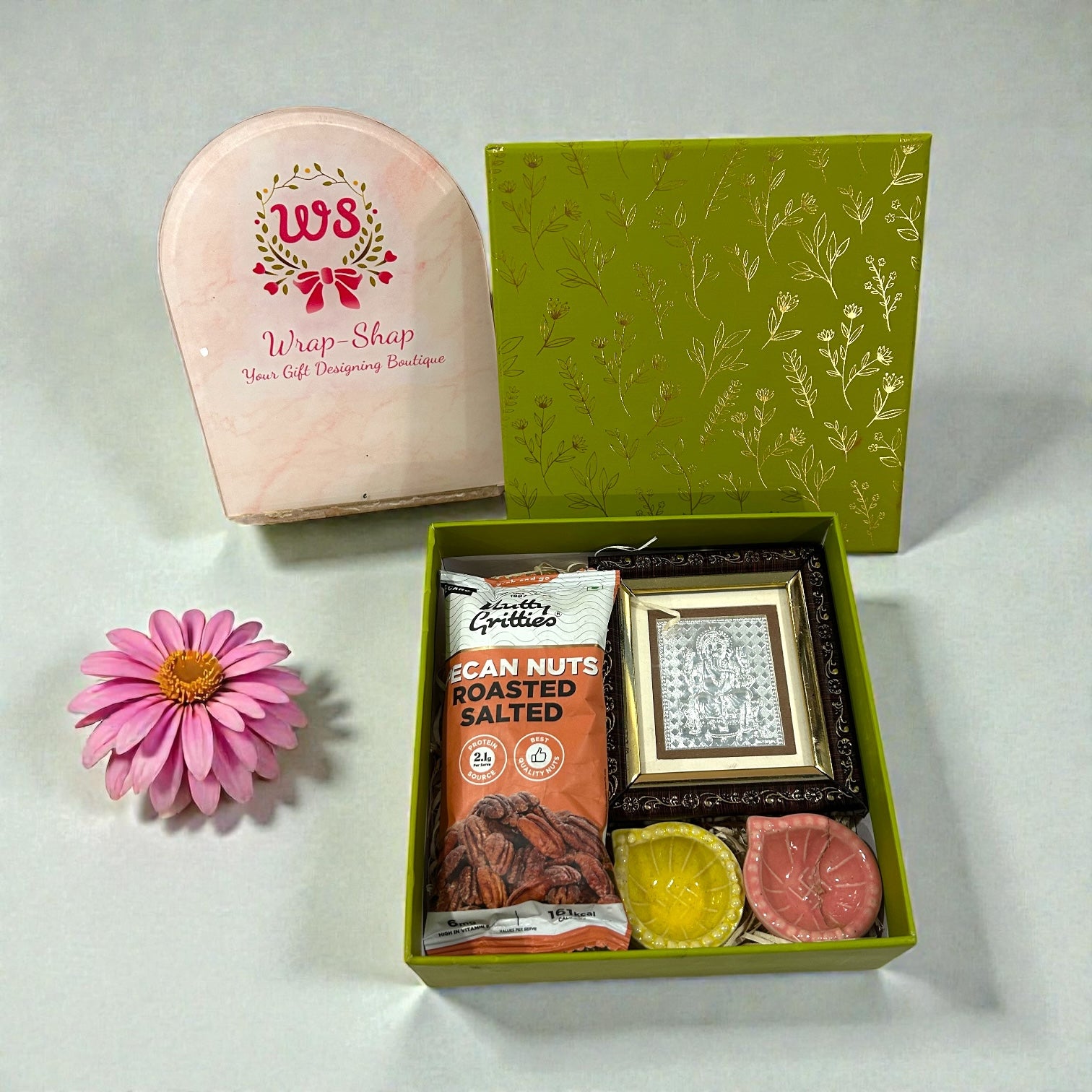 Premium wedding return gift featuring Ganesh silver frame, diyas and roasted nuts
