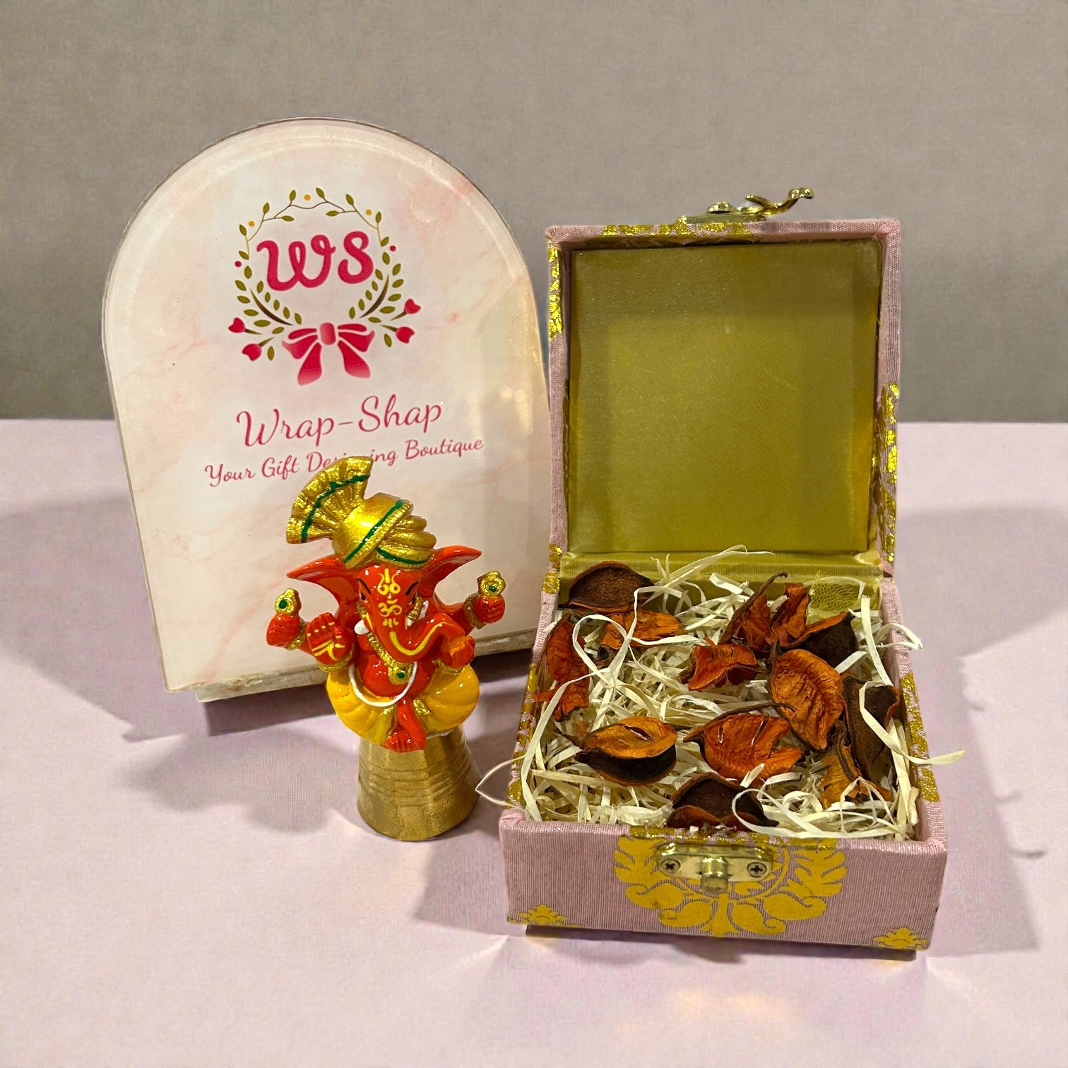 Traditional wedding return gift featuring Ganesh Ji idol in elegant gift box.