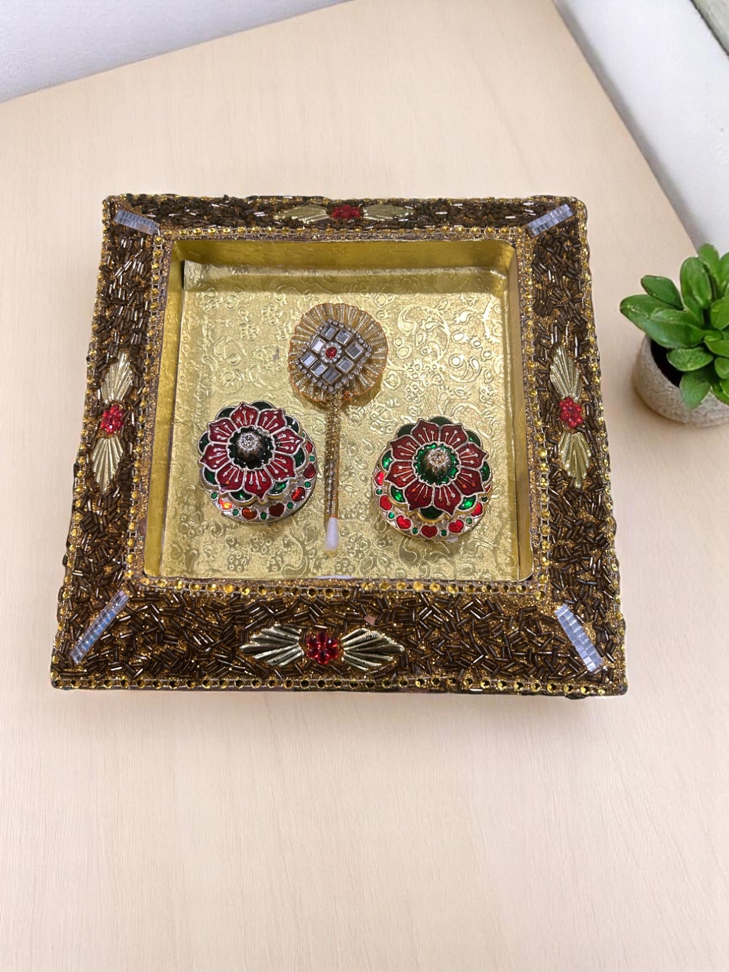 Golden lakh design tilak tray with roli chawal dibbi and tilak stick, perfect for pooja, wedding, Rakhi, and festive rituals from Wrap Shap