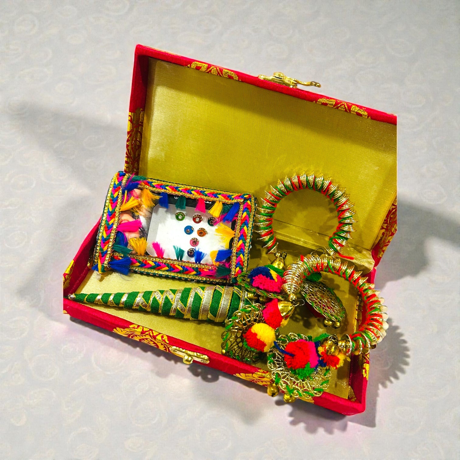 Haldi Mehendi wedding return gift for ladies featuring bindi, bangles and mehendi cone.
