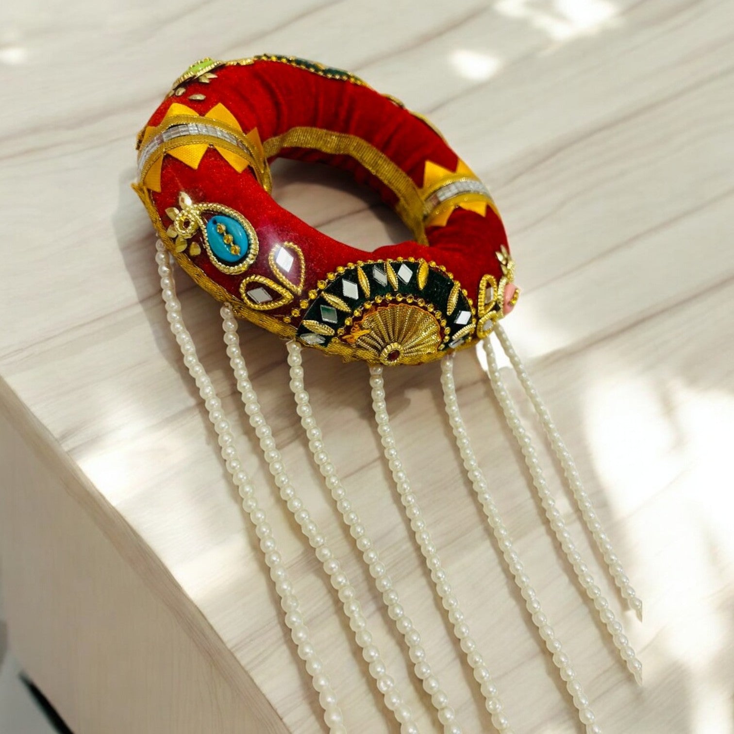 Traditional Indhi or Head Cushion with vibrant fabric and padding, used for carrying Ghara during Indian wedding Gharoli ceremonies.