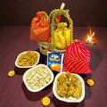 Lohri gift hamper in jute basket with colourful gota potli containing revdi, peanut chikki and moongfali