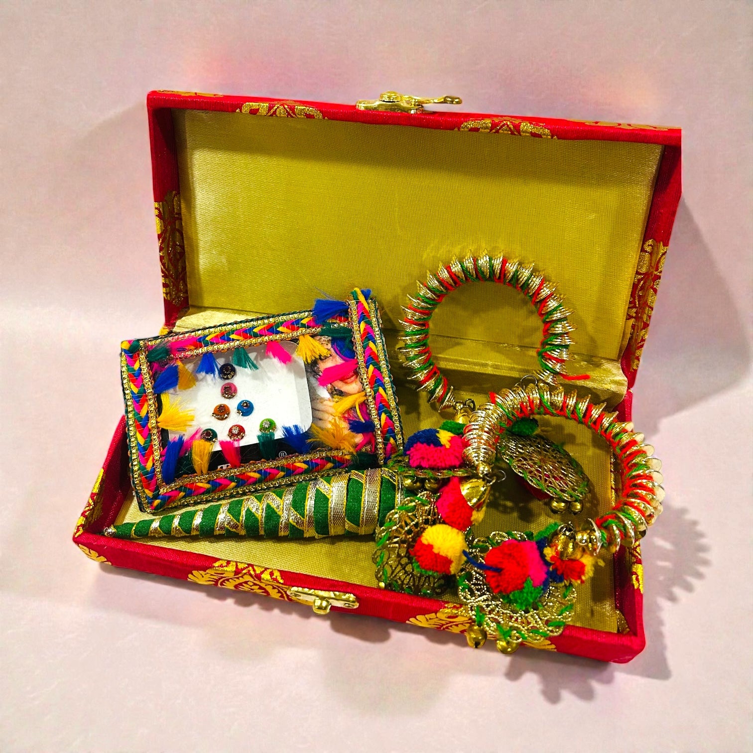 Haldi Mehendi wedding return gift for ladies featuring bindi, bangles and mehendi cone.