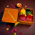 Kite shaped Lohri gift box with revdi, chikki, moongfali and popcorn in velvet potli.