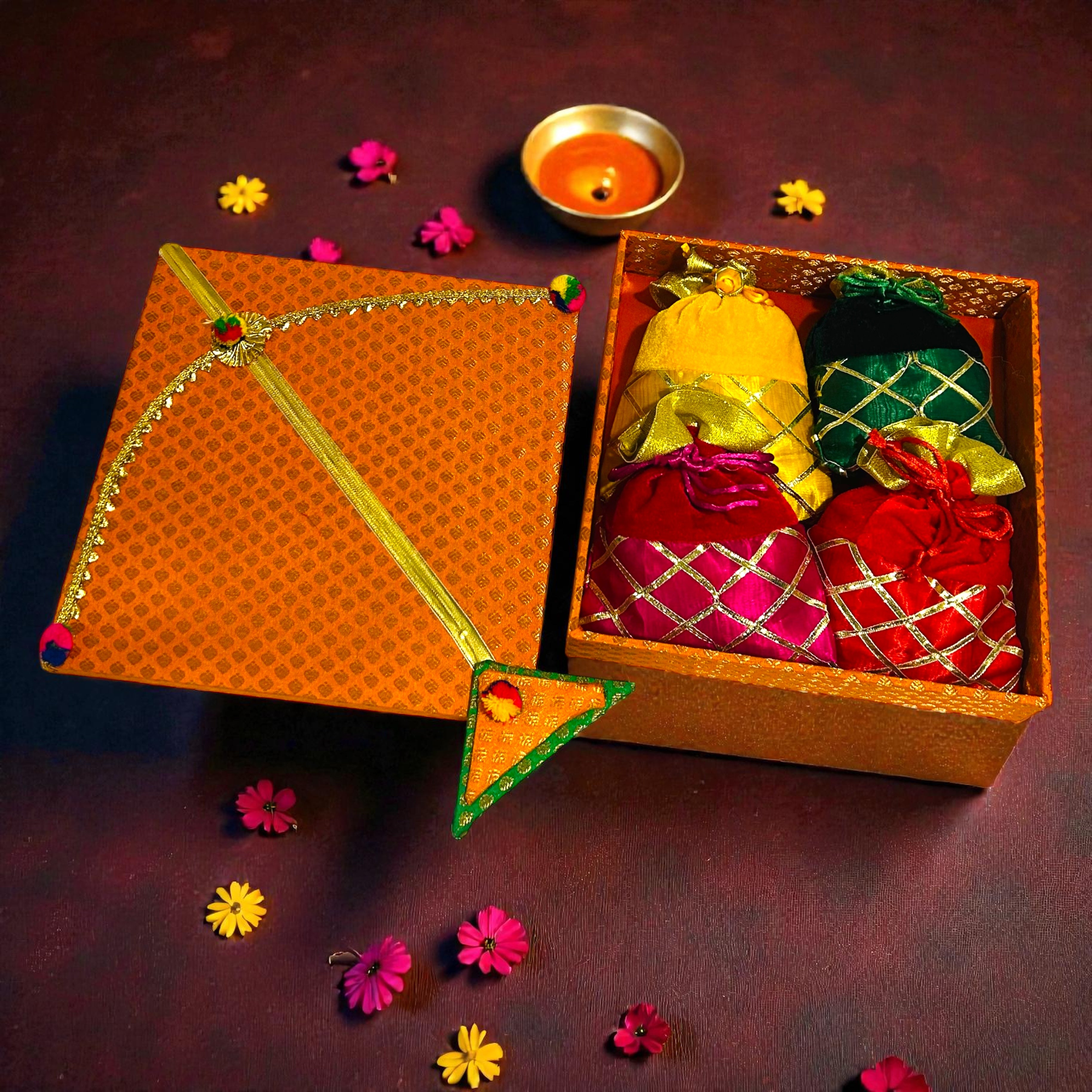 Kite shaped Lohri gift box with revdi, chikki, moongfali and popcorn in velvet potli.