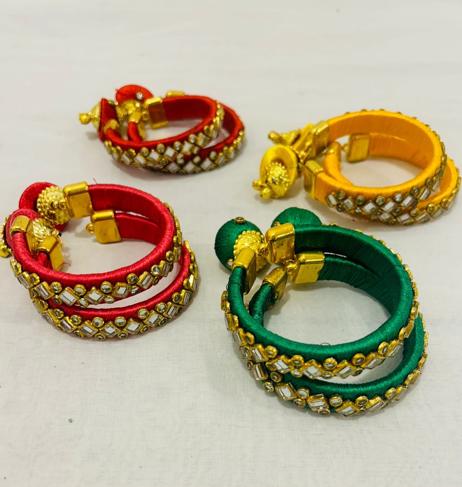Set of 2 Kundan Bangles in assorted colors with gold-plated detailing, perfect for wedding return favors, Mehendi gifts, Sangeet giveaways, and festive gifting.