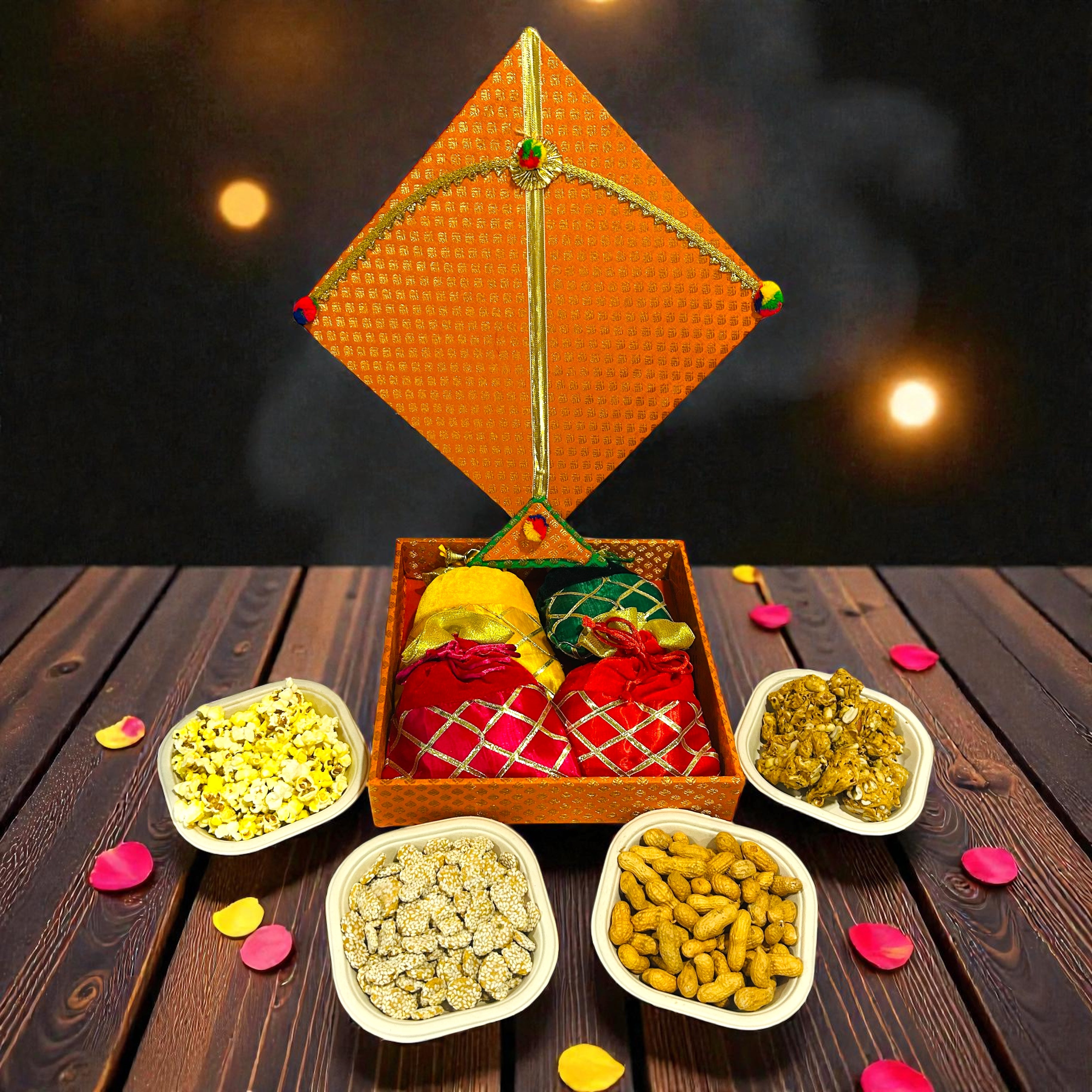Festive Lohri hamper in kite shaped box with traditional snacks and velvet potli.