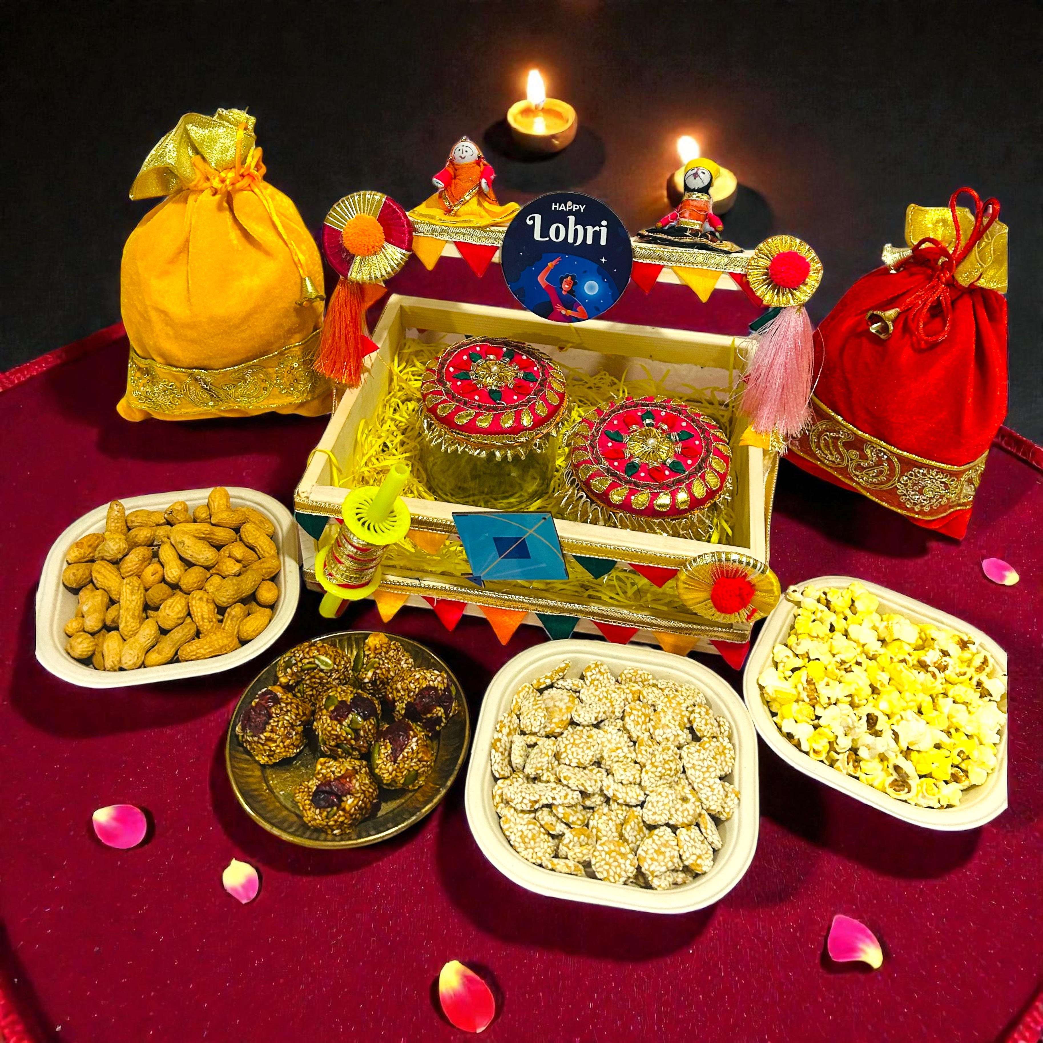 Lohri themed pine basket hamper with velvet potlis, popcorn, moongfali and traditional sweets.