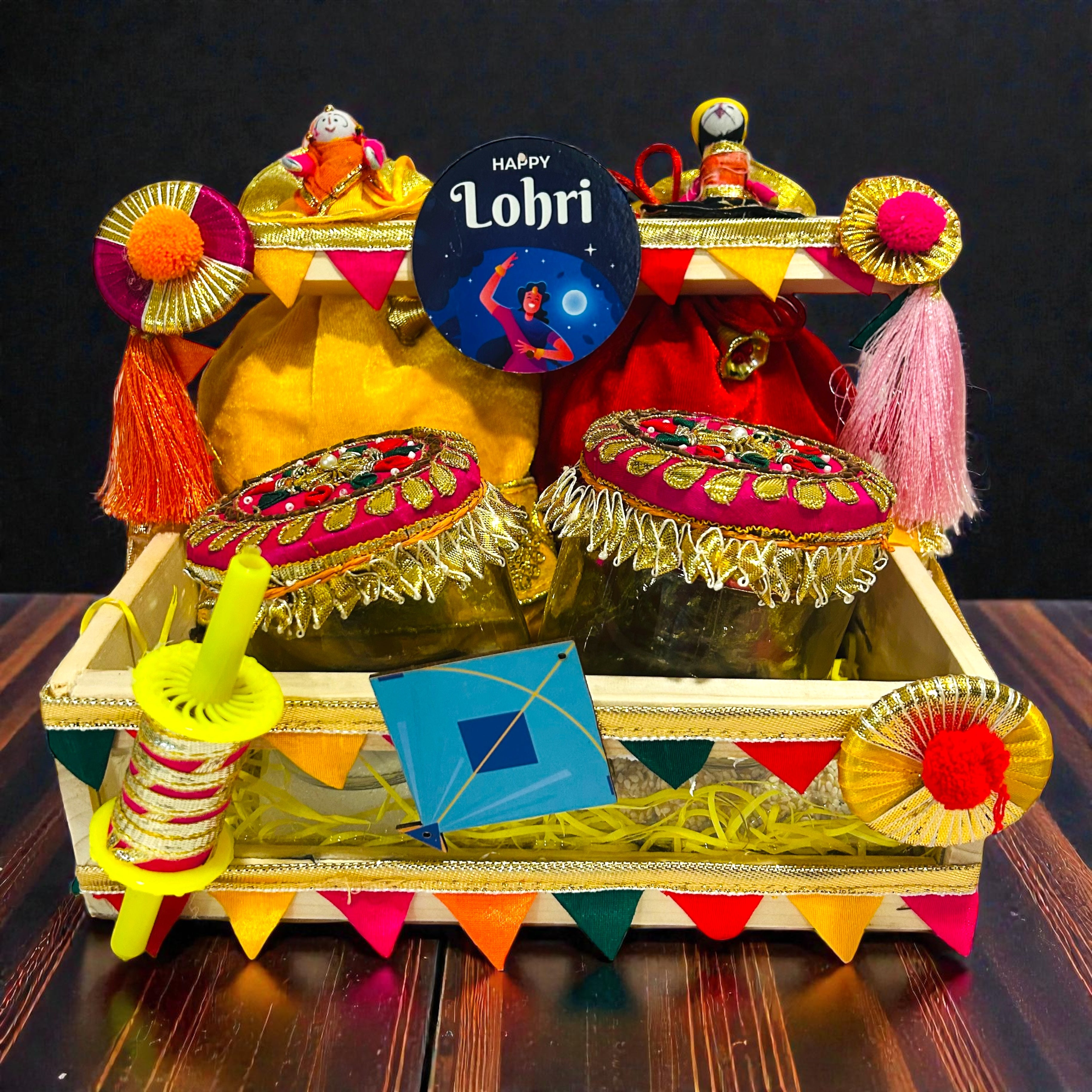 Lohri themed pine basket hamper with velvet potlis, popcorn, moongfali and traditional sweets.