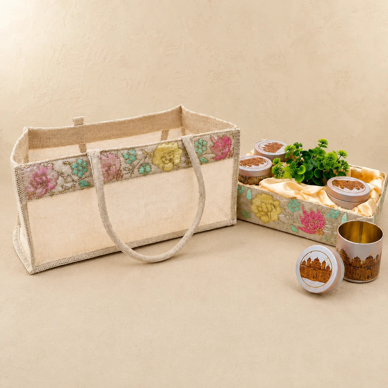 Premium Lotus open tray hamper gift set with four tin jars, artificial plant, and reusable Jute PVC carry bag for corporate, wedding, and festive gifting.