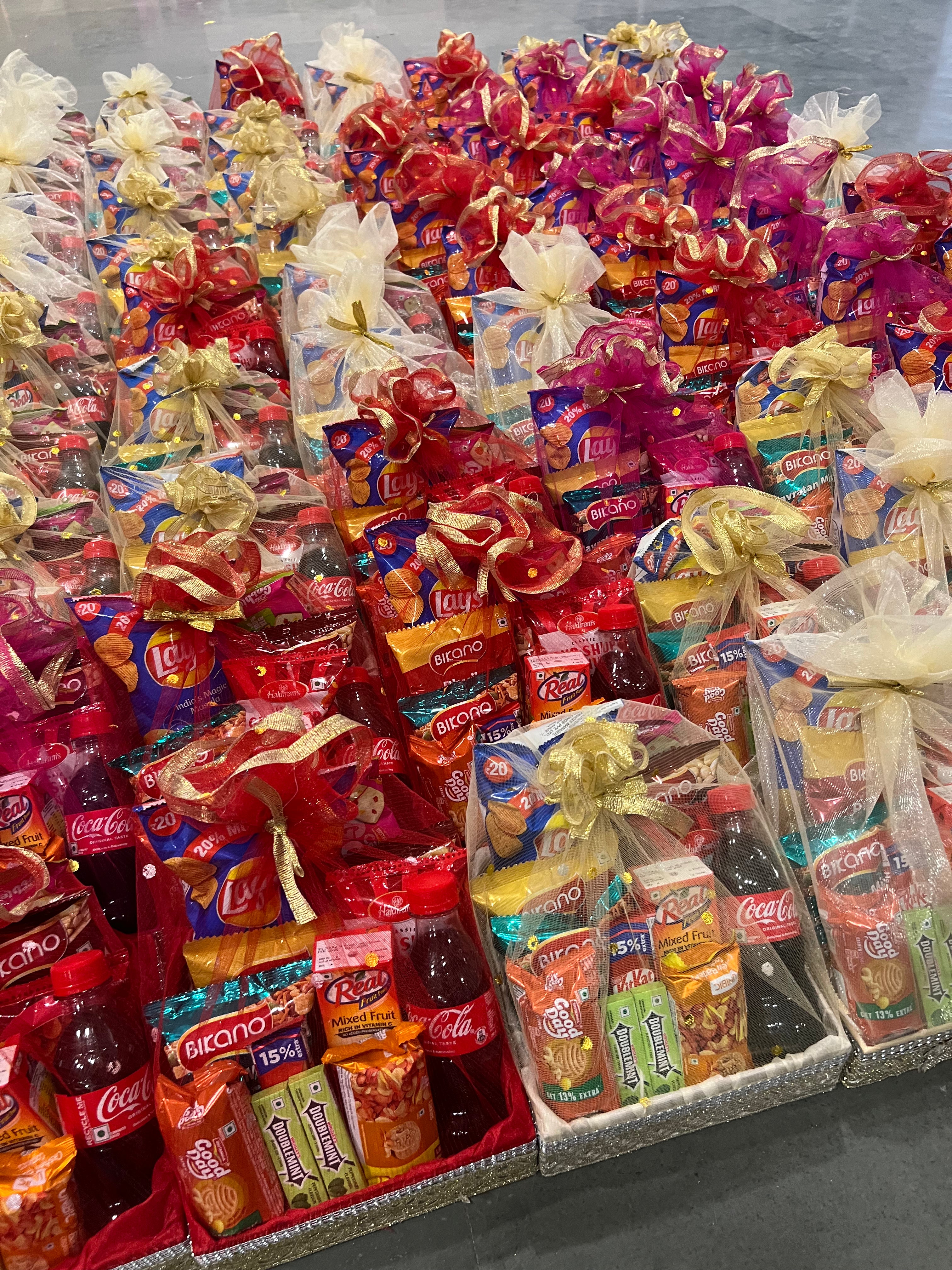 Low-price snack gift hamper containing assorted snacks and drinks in a basket.