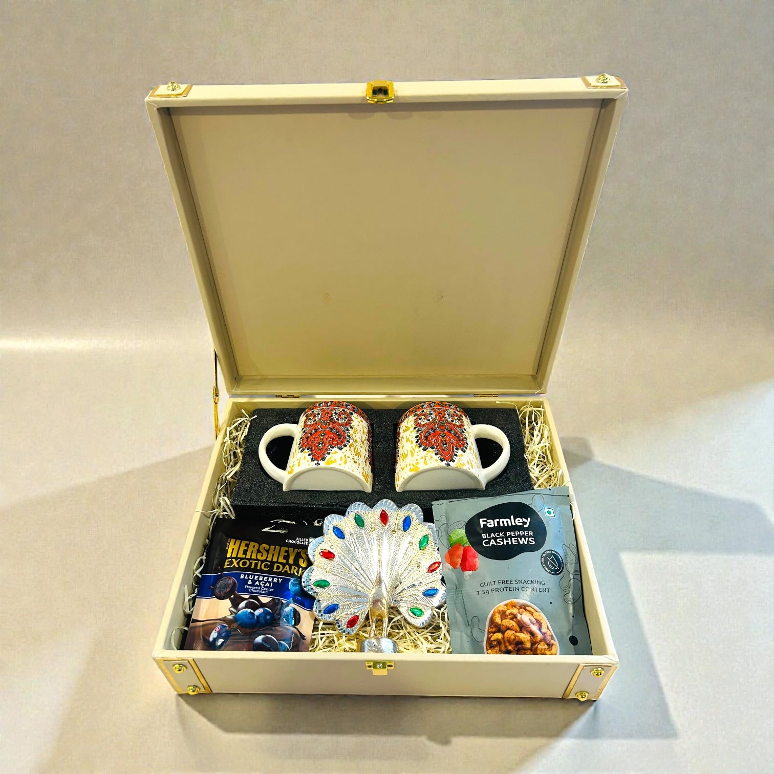 Luxury customized wedding return gift hamper with ceramic mug set, silver peacock and chocolates