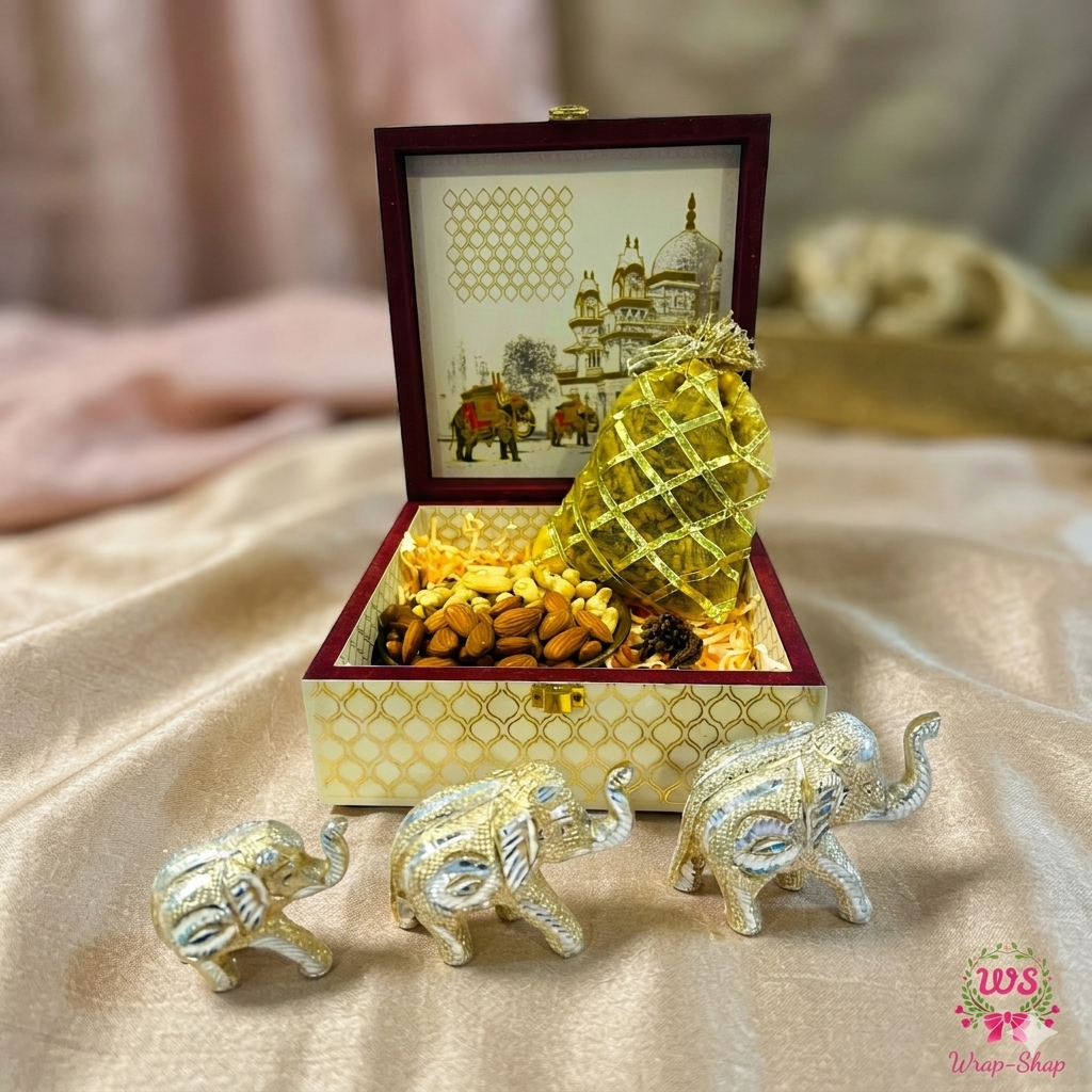 Luxury wedding return gift hamper with metal elephant showpieces and dry fruits in wooden box
