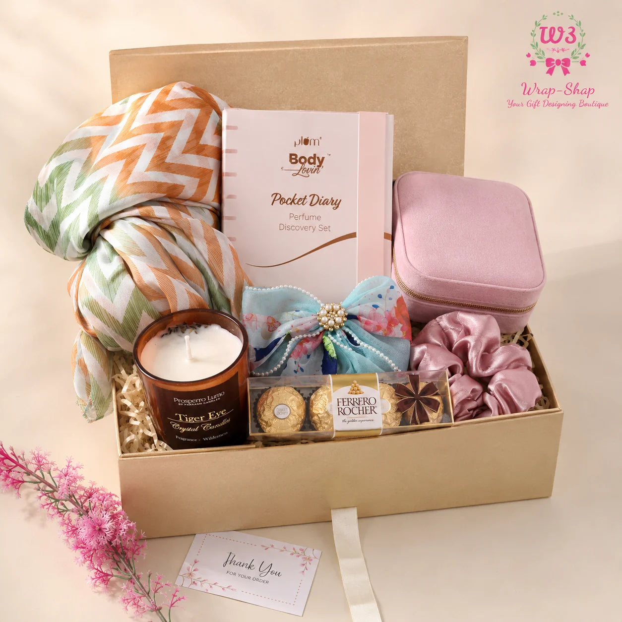 Luxury Women’s Gift Hamper by Wrap Shap featuring a printed silk-blend stole, Plum mini perfume set, jewellery pouch, designer hair pin, scrunchies, scented candle, Ferrero Rocher chocolates, thank-you card, and premium gift box packaging.