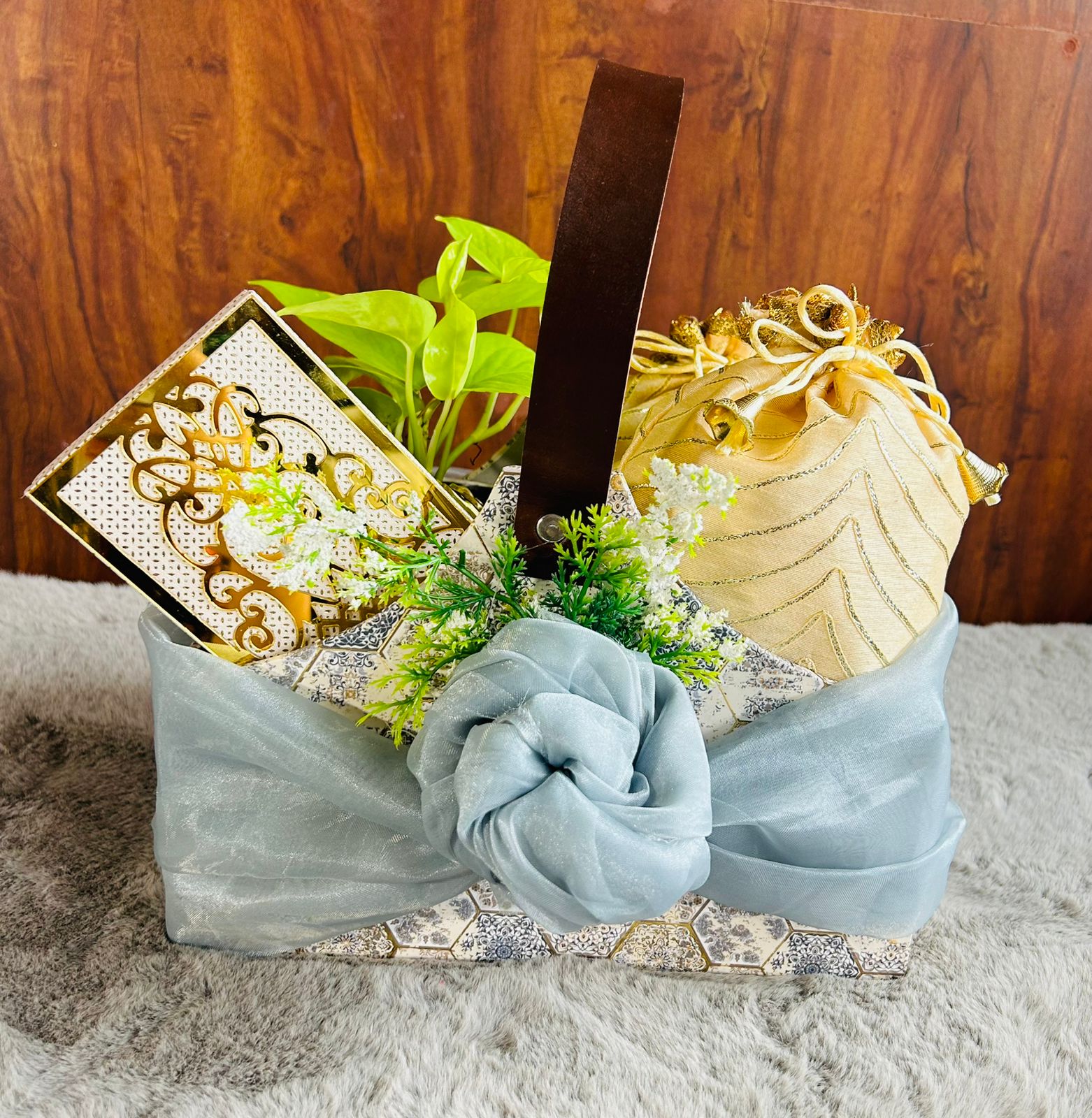 Luxury MDF Diwali hamper wrapped in Furoshiki style with dry fruits, chocolates, diyas, and self-watering plant