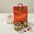 Return favour with meenakari laddoo box, Laddoo Gopal statue and leheriya cloth bag.