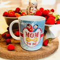 White ceramic “Mom to Be” coffee mug with elegant typography – perfect baby shower and pregnancy reveal gift from Wrap Shap