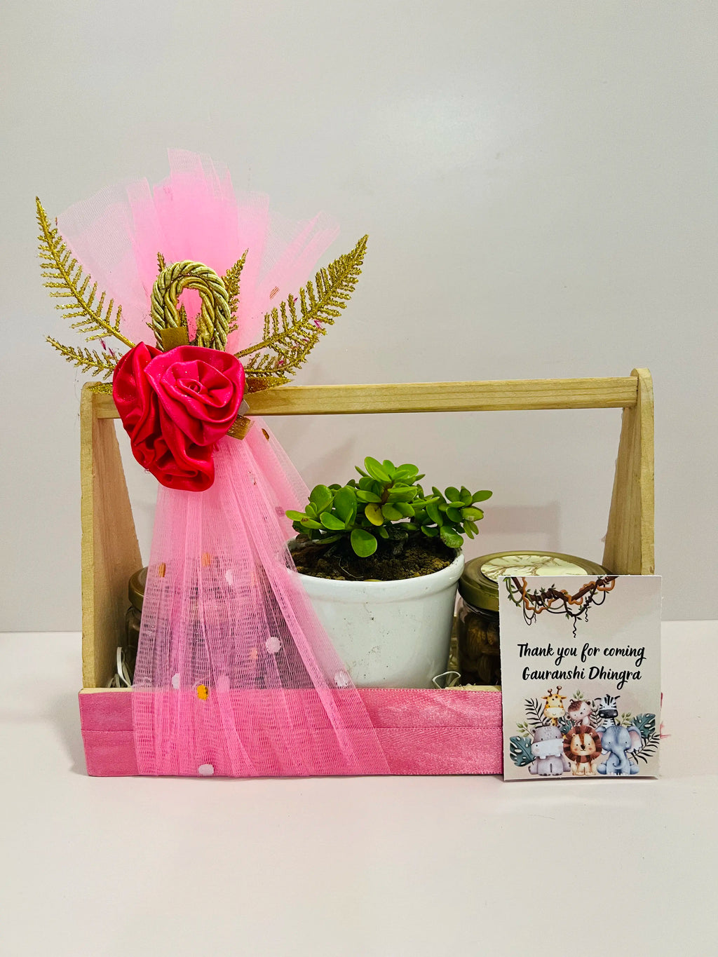 Baby return gift hamper with jade plant, almonds and raisins in decorated pinewood basket