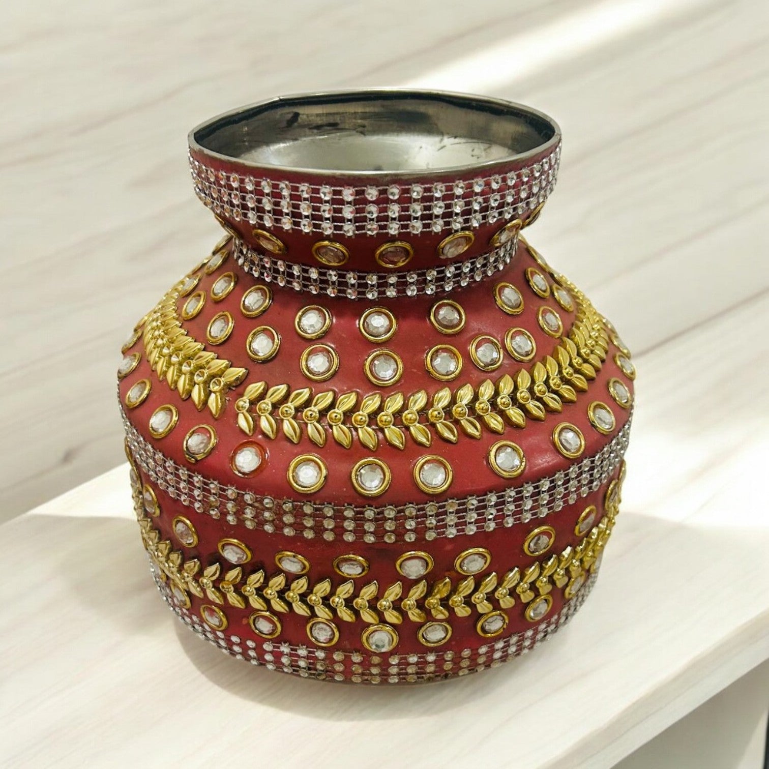 Decorated pastel shade heavy steel ghara with lace and embellishments, used for Gharoli and Haldi ceremony in Indian weddings.