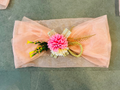 Peach tissue net tray cover with floral bunch decoration