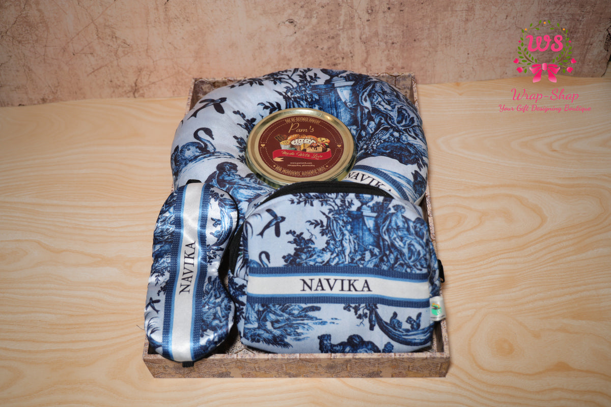 Wrap Shap personalized travel gift hamper for sister with neck pillow, eye mask, pouch and handmade chocolates in festive tray for Rakhi gifting