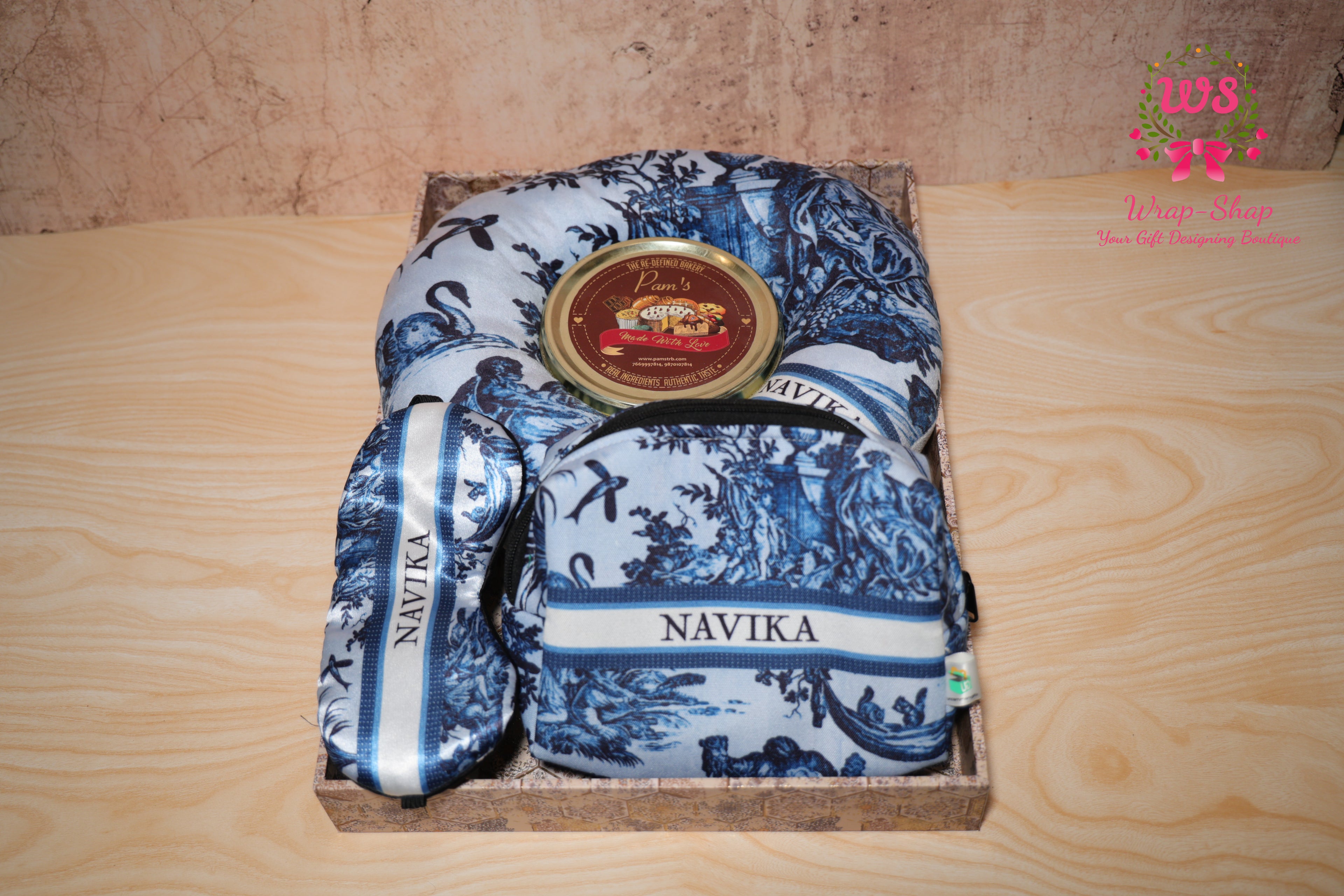 Wrap Shap personalized travel gift hamper for sister with neck pillow, eye mask, pouch and handmade chocolates in festive tray for Rakhi gifting