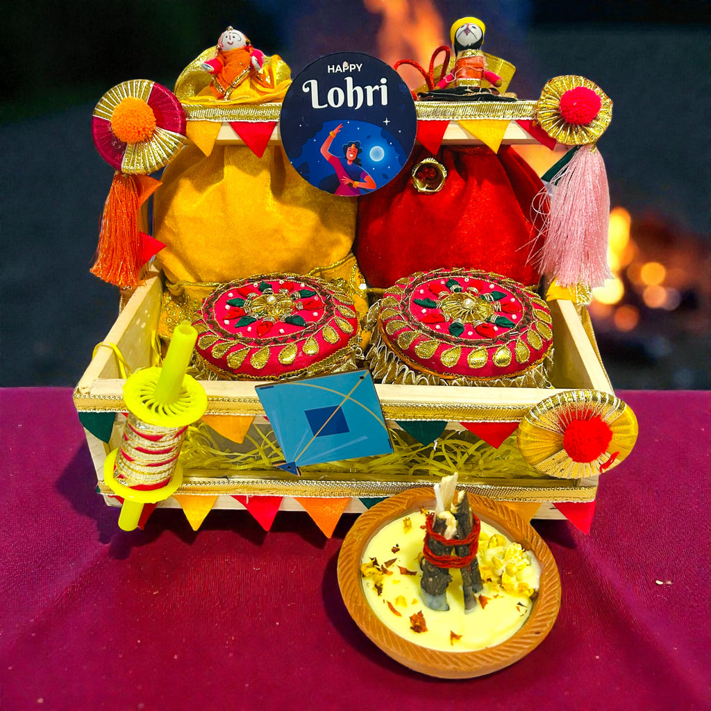 Premium Lohri gift hamper in pine basket with velvet potlis, til laddoo and gur revdi jars.
