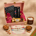 Wrap Shap Signature Rakhi Trunk featuring a Premium AD Rakhi, almonds, raisins in designer potli bags, Ferrero Rocher chocolates, scented candle, premium notebook, branded pen set, roli chawal, personalized greeting card, and a luxury solid wooden trunk for Raksha Bandhan gifting.