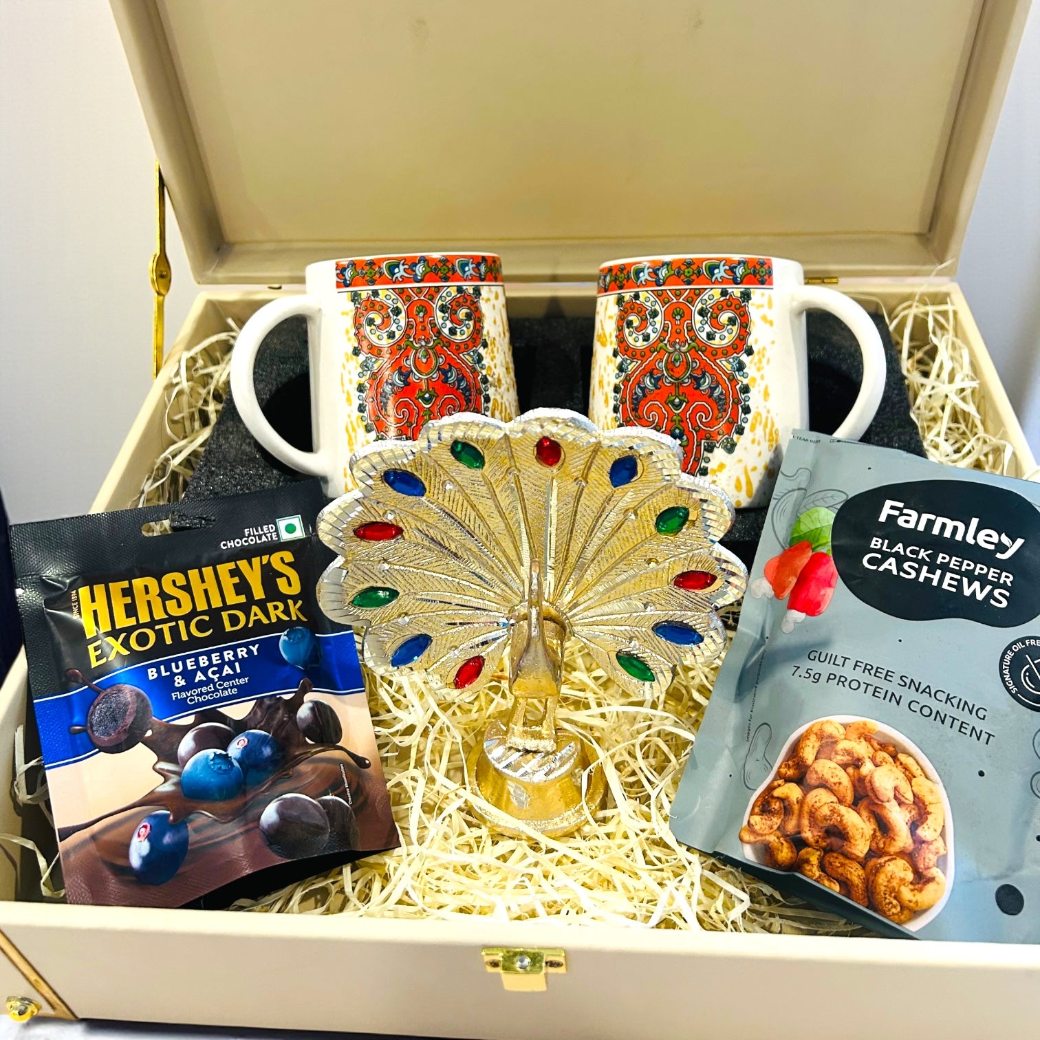 Exclusive premium wedding return gift hamper with ceramic mugs, peacock showpiece and dry fruits in leatherette box