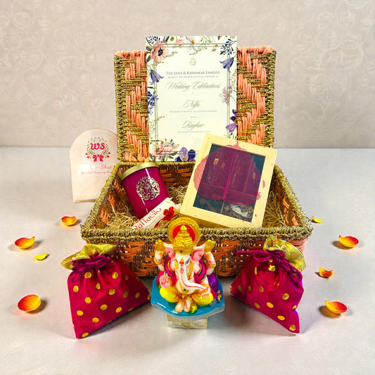 Premium wedding return gift hamper in rafia rope box with Ganesh statue, scented candle, chocolates and dry fruits