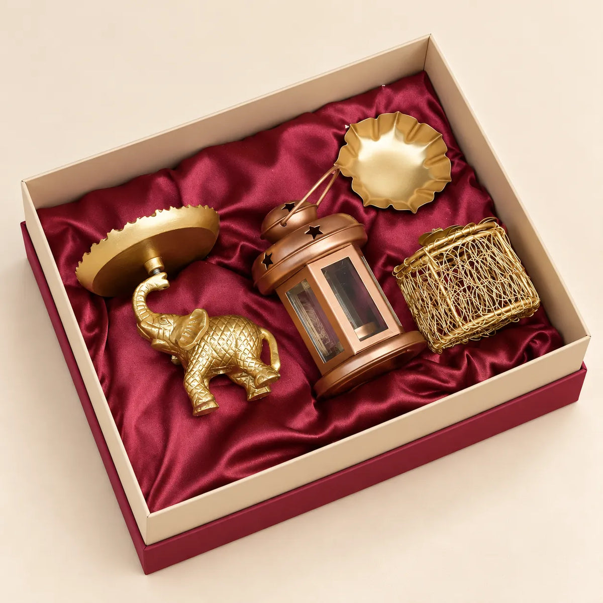 Regal elephant platter and lotus urli decorative gift set by Wrap Shap, premium metal décor gift set with elephant platter and lotus urli, festive metal gifting set for Diwali and corporate occasions, elephant-themed home décor gift set with decorative metal boxes, premium traditional Indian décor gift set for wedding and housewarming gifting.
