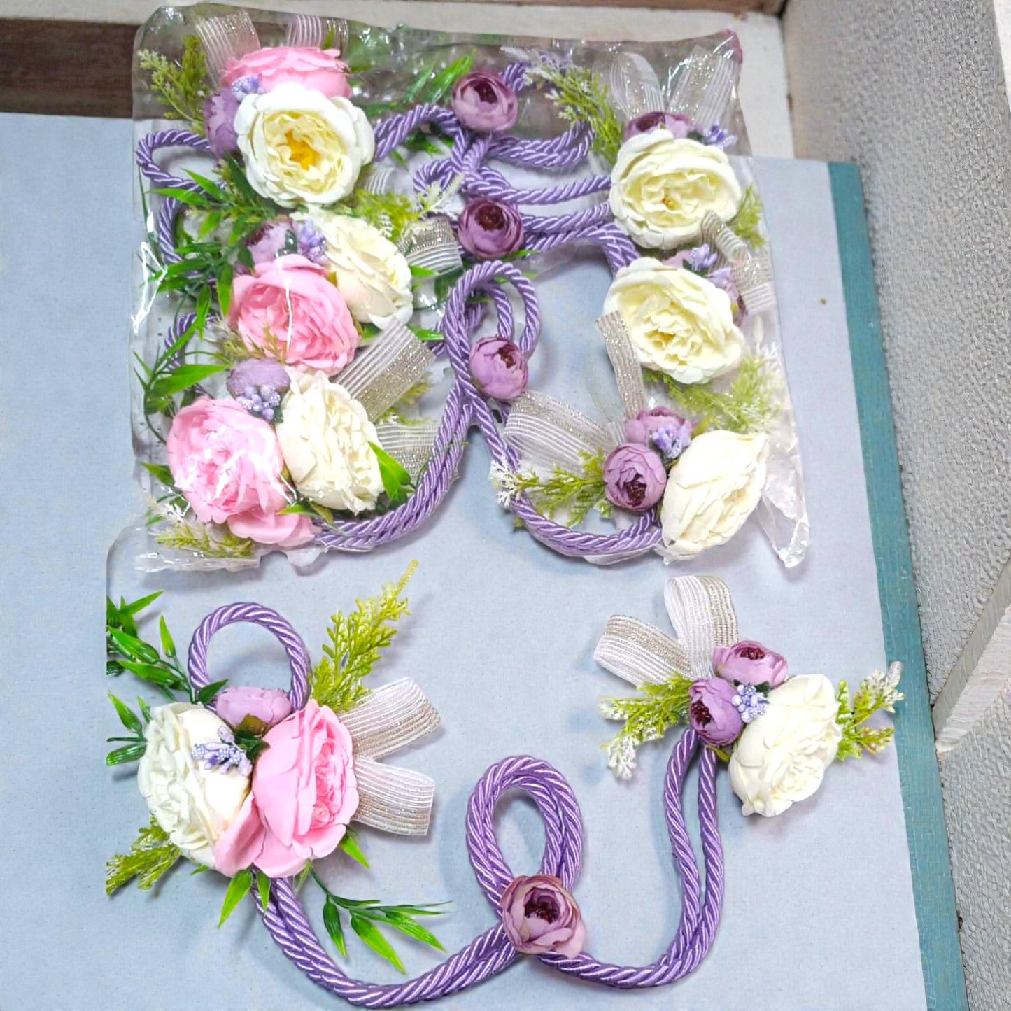 Rope-style pastel artificial flower bunch in pink, white and purple for hamper and trousseau packing.