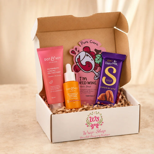 Skincare Essentials Box by Wrap Shap featuring a face wash, face serum, sheet mask, Cadbury Dairy Milk chocolate, and premium gift box packaging for Raksha Bandhan and festive gifting.