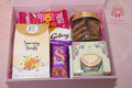 Wrap Shap gift hamper with savoury snacks, Galaxy and Dairy Milk chocolates, cookies in jar, scented candle and protein bar in a reusable rigid box