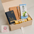 Personalised student graduation and exam success gift hamper with passport holder, cork diary, pen set, coffee and Ferrero Rocher chocolates in a premium gift box by Wrap Shap.